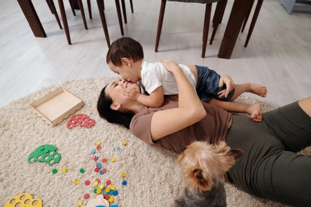 Woman playing with child on floor