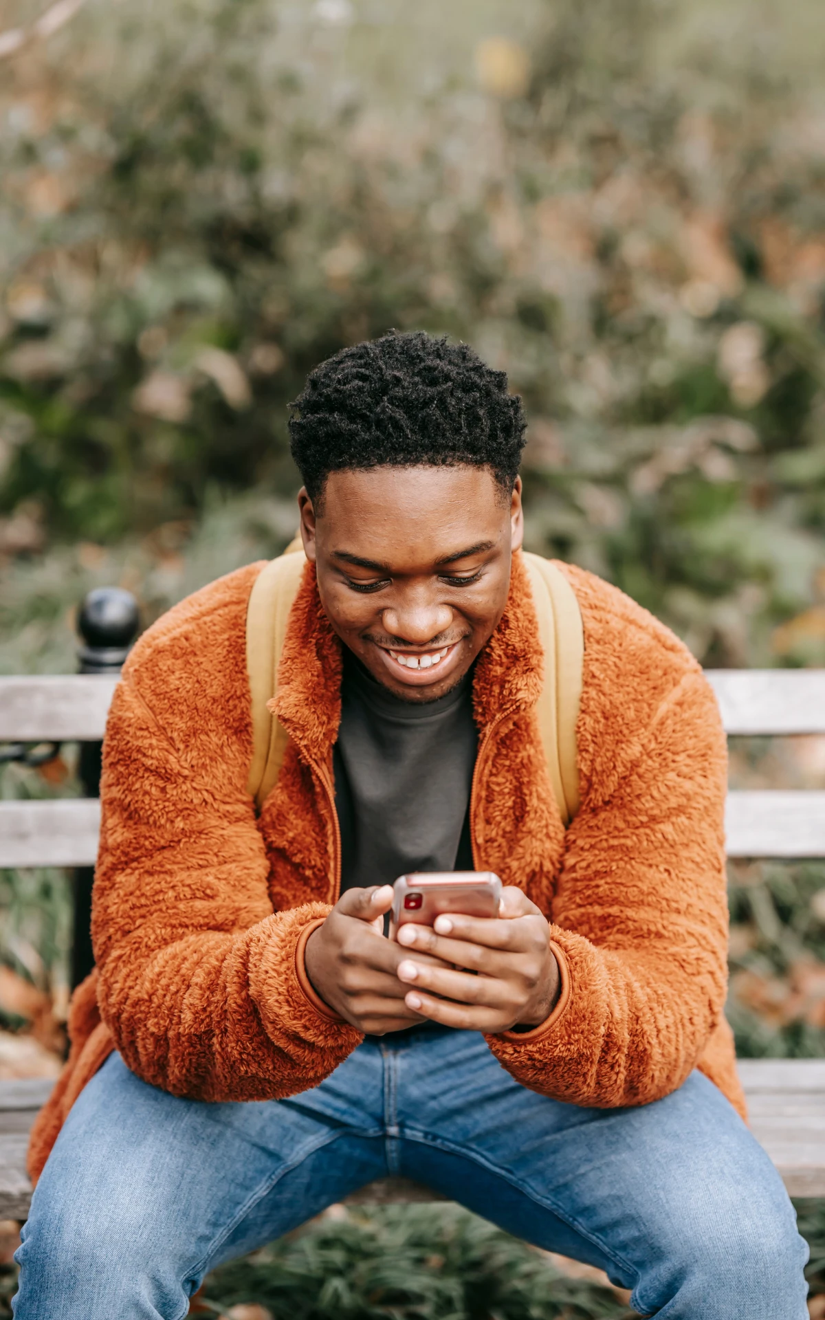 man on bench with phone