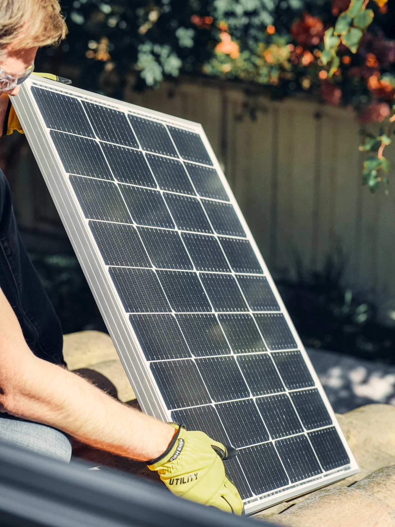 worker holding solar panel whilst on a roof - Looking for a new build home this bank holiday